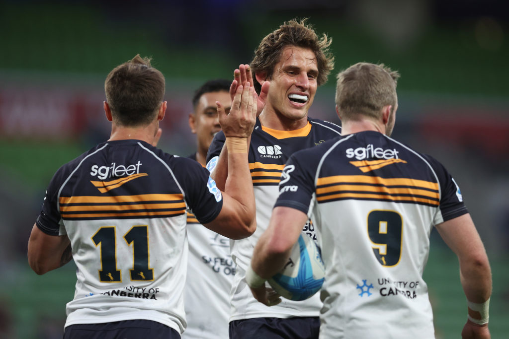 MELBOURNE, AUSTRALIA - FEBRUARY 23: Corey Toole of the Brumbies (L) celebrates scoring a try with Ollie Sapsford of the Brumbies and Ryan Lonergan of the Brumbies (R) during the round one Super Rugby Pacific match between Melbourne Rebels and ACT Brumbies at AAMI Park, on February 23, 2024, in Melbourne, Australia. (Photo by Daniel Pockett/Getty Images)