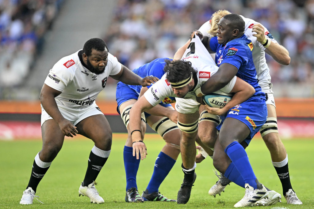 Emile van Heerden of the Sharks is tackled by Sti Sithole and Adre Smith of the Stormers during the 2023 United Rugby Championship game between the Stormers and Sharks at Cape Town Stadium on 30 December 2023 ©Ryan Wilkisky/BackpagePix