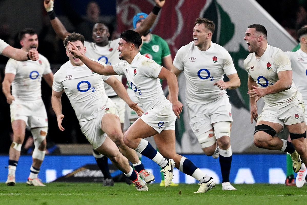 LONDON, ENGLAND - MARCH 09: Marcus Smith of England celebrates scoring the winning drop goal as teammates celebrate behind during the Guinness Six Nations 2024 match between England and Ireland at Twickenham Stadium on March 09, 2024 in London, England. (Photo by Mike Hewitt/Getty Images)